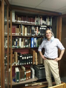 man standing in front of books